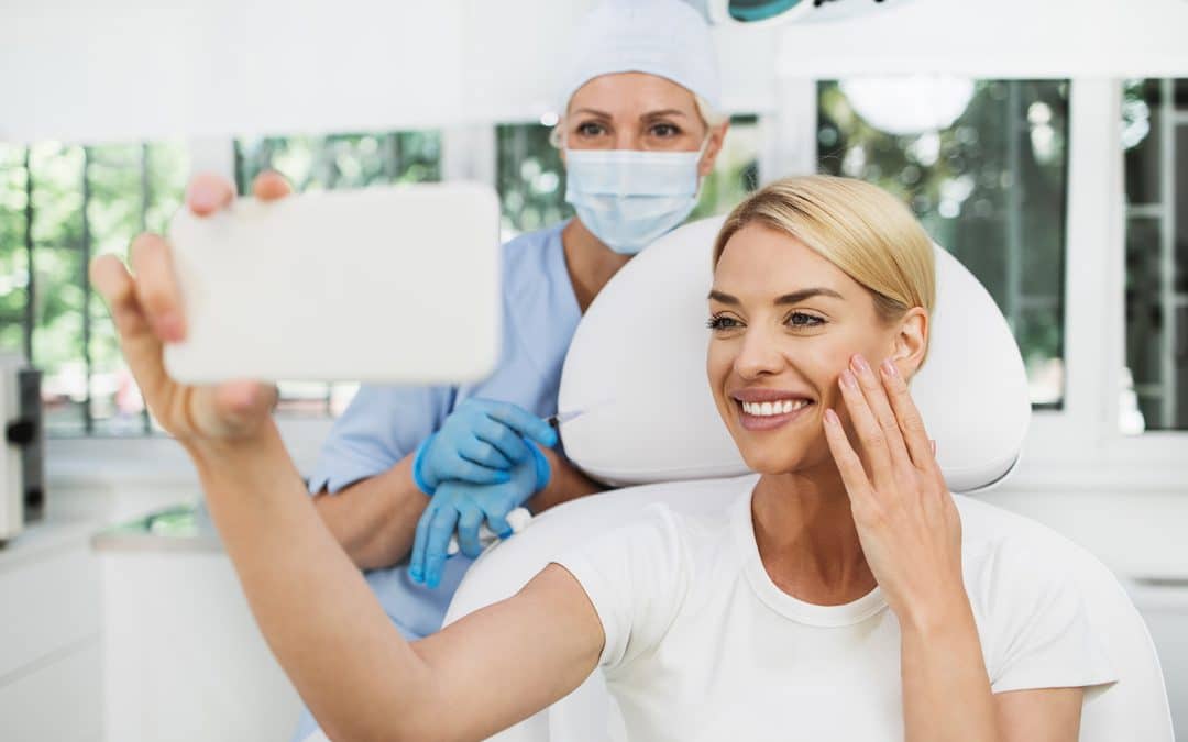 woman and dr seale looking into a mirror during a botox and dermal filler consultation at iheart dental