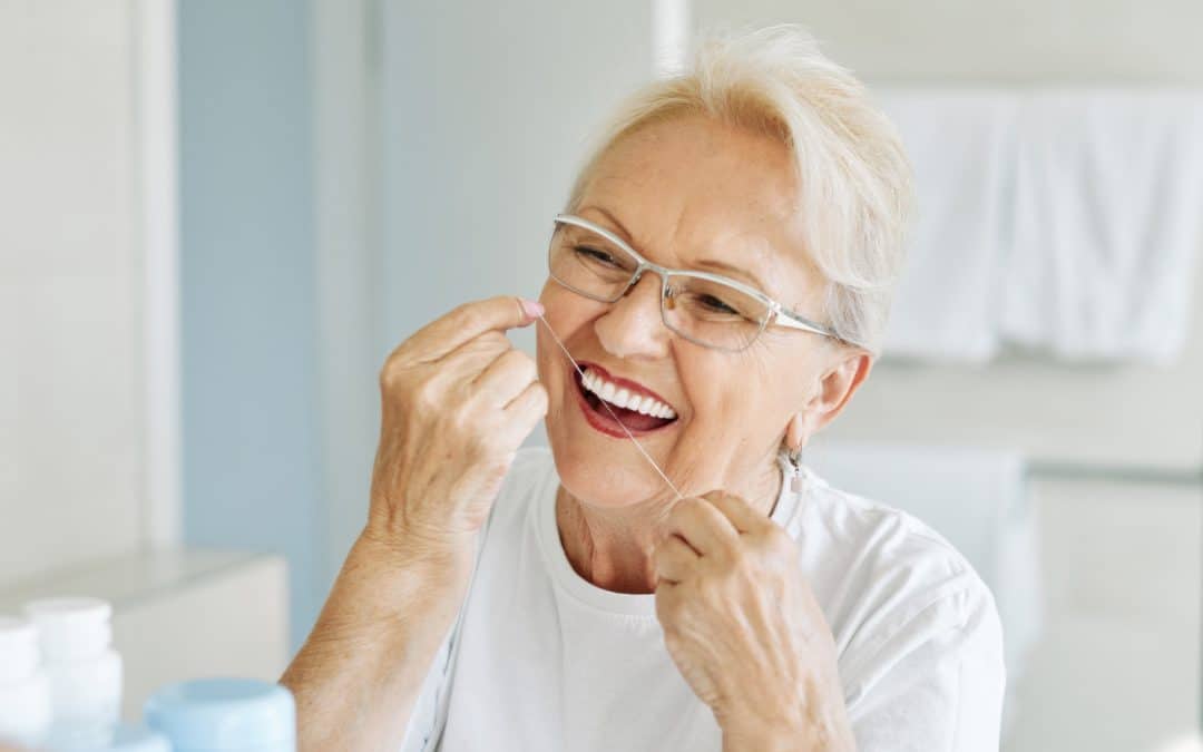 Woman cleaning her dental implants in Rincon GA